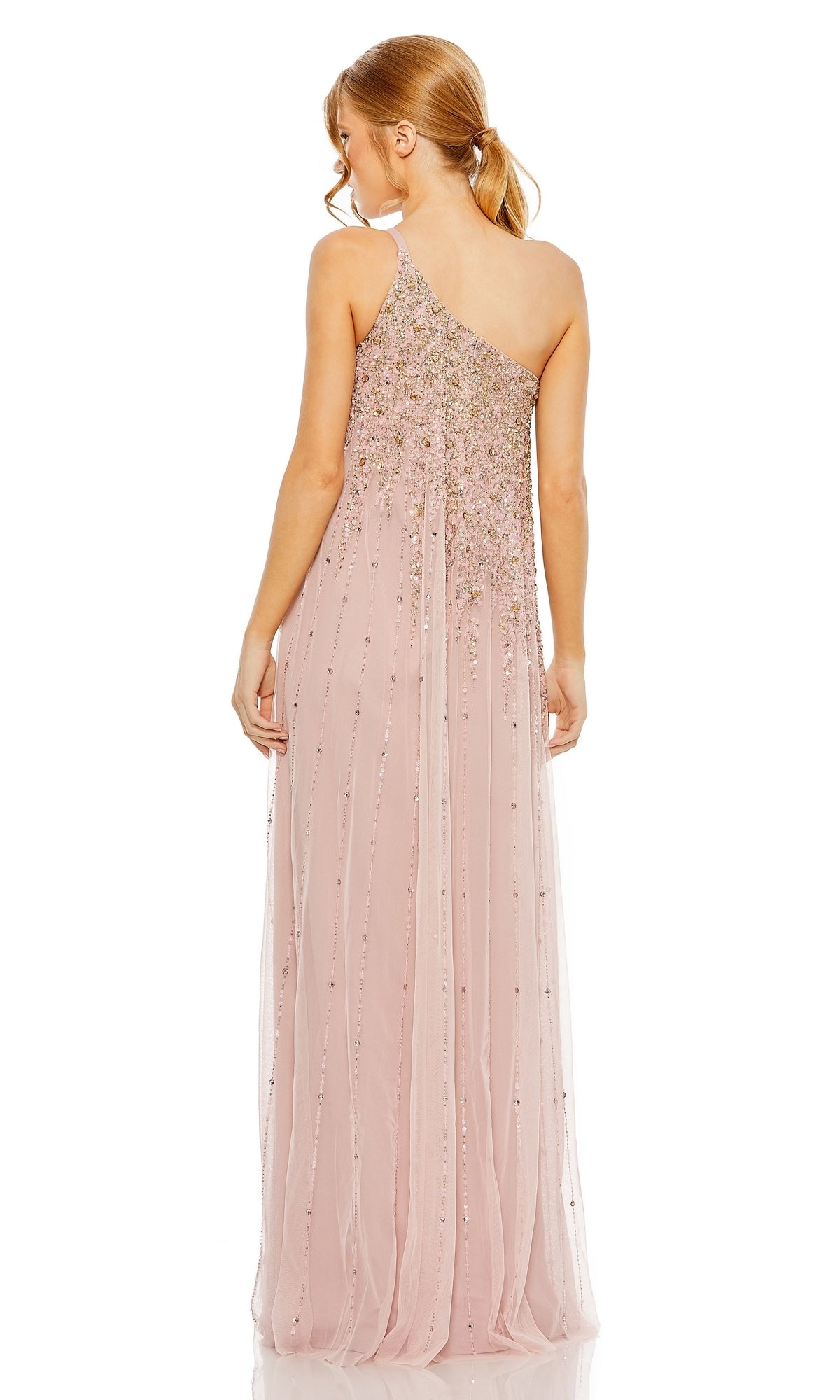A woman in the Mac Duggal 9224 one-shoulder long formal dress, featuring light pink fabric and bead embellishments, stands facing away from the camera.